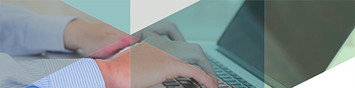 Hands typing on a laptop keyboard