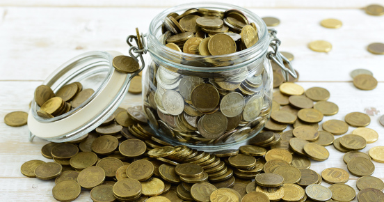 Glass jar filled with coins